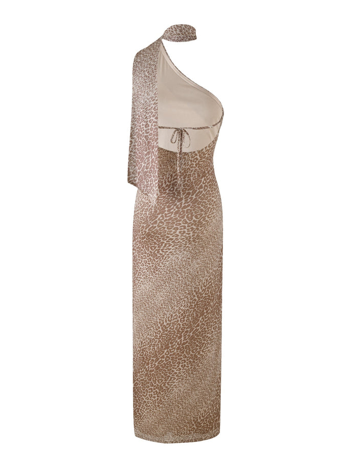 Introducing the ALLIRA MAXI DRESS - NEUTRAL : LEOPARD by TIGERMIST: a striking one-shoulder, sleeveless dress featuring a brown and beige leopard print pattern. Made from stretch fabric, it boasts an asymmetrical neckline, a fitted waist with an adjustable tie, and a long hemline for an effortlessly chic appearance.