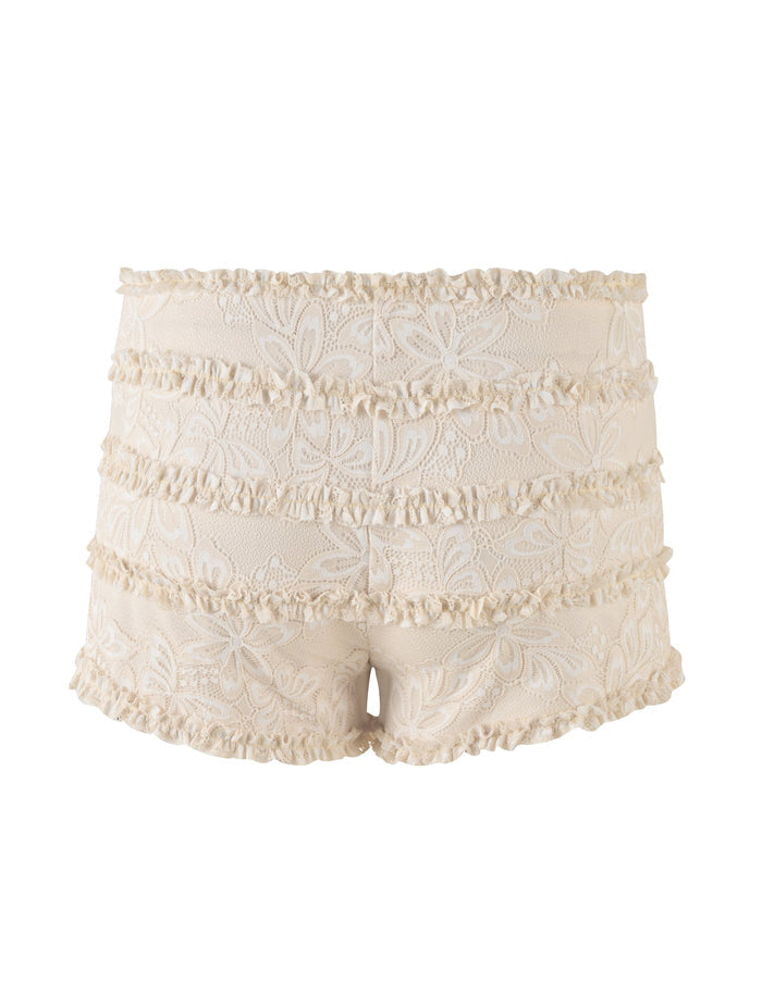 Introducing the ANELISA SHORT - WHITE : LACE by TIGERMIST, a pair of delicate white lace mini shorts adorned with tiered ruffles. The fabric features an intricate floral pattern and a mid-rise waist. These feminine shorts boast a scalloped hemline, making them the perfect elegant addition to your summer wardrobe.