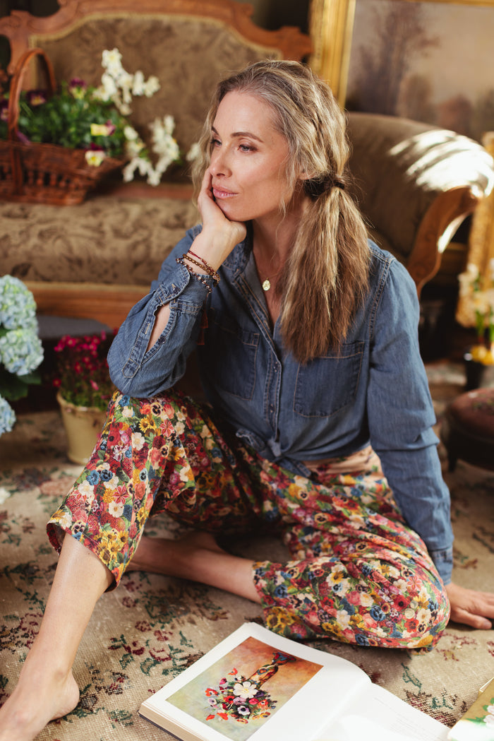 Artist pants featuring a whimsical print of 50 antique seed catalogue flowers arranged on a painter’s palette with a Monet quote – Market of Stars.