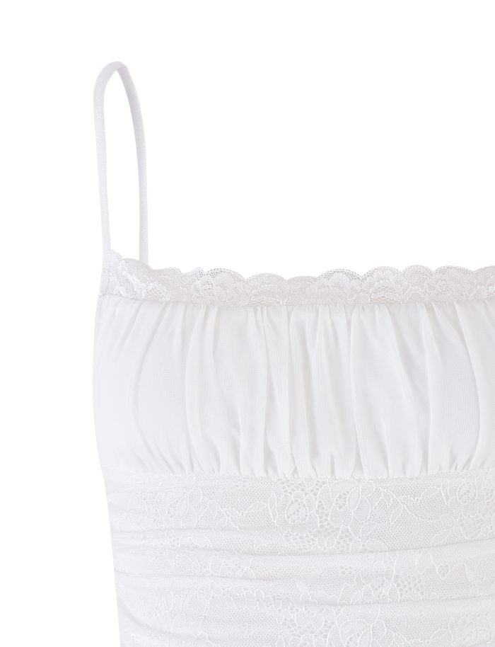 The AVALYN TOP - WHITE by TIGERMIST features thin spaghetti straps, a lace-trimmed neckline, ruched detailing, and a delicate lace band below the bust. Made from soft, lightweight stretch fabric for extra comfort.