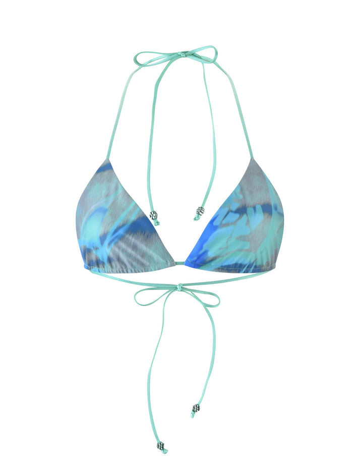 Introducing the AVE Bikini Top from TIGERMIST, a stunning halter neck triangle bikini top in a vibrant multi-colored floral tie-dye pattern. Featuring back tie closures and small decorative beads on the ends of the ties, this piece showcases shades of blue with subtle accents of white and gray.