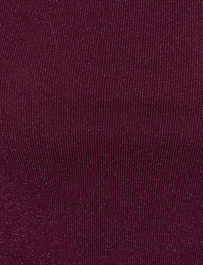 A close-up of the COBI MINI DRESS 2.0 from TIGERMIST reveals its maroon ribbed fabric adorned with delicate silver speckles, creating a subtle shimmering effect similar to glitter. The fabric is slightly stretchy and features closely spaced vertical lines, making it ideal for crafting an asymmetrical dress or a chic Cobi Tank.