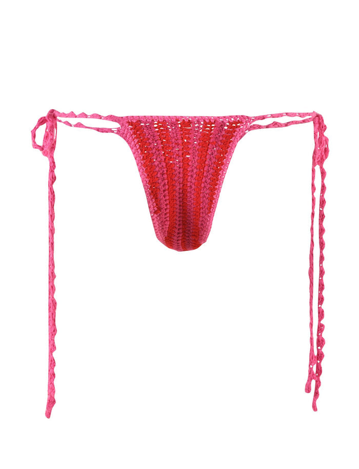 The CORA BIKINI BOTTOM - PINK : STRIPE by TIGERMIST is a pink crocheted piece with side ties, featuring a cheeky bikini cut. The playful design alternates vertical stripes of darker and lighter shades of pink, creating a fun red and pink striped look. The ties have a wavy texture for added flair.