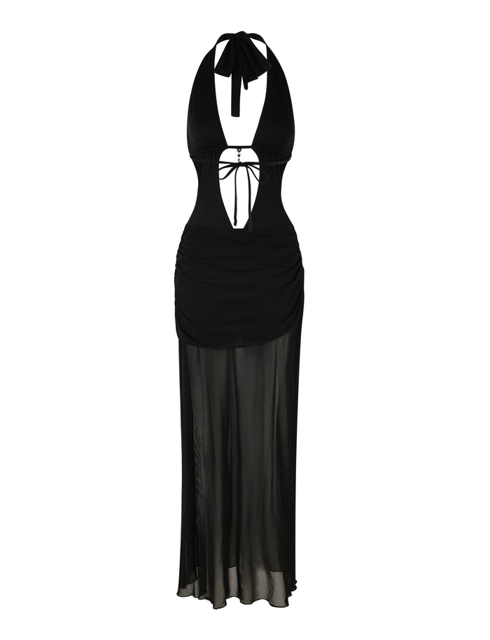 The Esha Maxi Dress from Tigermist is a black, sleeveless, halter-neck dress featuring a deep V-cut in the front accentuated by a bow at the bust. It boasts a ruched waist and a revealing midriff, complemented by sheer, flowing fabric that extends to maxi length, creating an elegant bodycon silhouette.