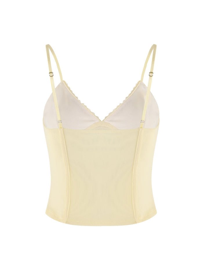 The FENNEL TOP - YELLOW by TIGERMIST is a pale yellow cami that boasts thin adjustable straps and a V-neckline. It's crafted from a soft, slightly sheer material with a fitted, sleeveless silhouette, accented with delicate lace trim—perfect for layering or wearing on its own.