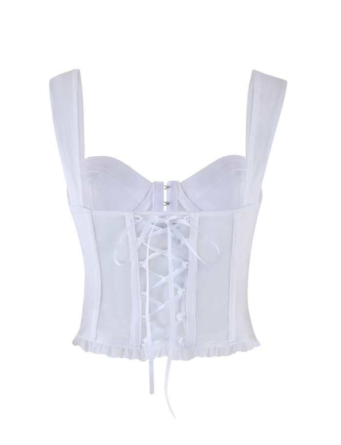 The GINNY TOP - WHITE by TIGERMIST is an optic white corset-style top with wide straps, structured cups, a back zipper, crisscross lace-up back detail, and a subtly frayed hem for added style.