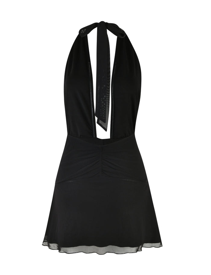 The HALIMA MINI DRESS - BLACK by TIGERMIST is a sleeveless halter dress with a ruched bodice and a flowing A-line skirt. It features a deep V-neckline and ties at the back, effortlessly blending simplicity with elegance for a truly classic and sophisticated look.