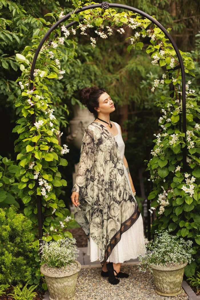 Model wearing a bamboo-viscose scarf featuring black-and-ivory floral lithographs from the 1900's - Market of Stars