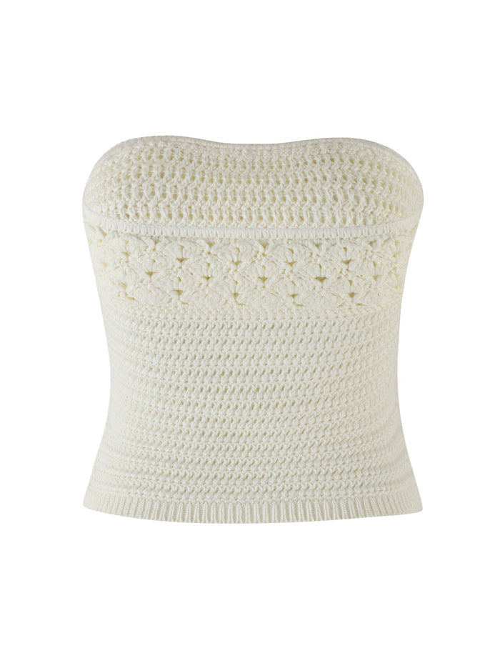 The JONAS TOP - WHITE : CREAM by TIGERMIST is a fitted, cream-colored crochet bandeau top with a textured pattern. It showcases intricate detailing in the midsection and has a slightly flared bottom hem.