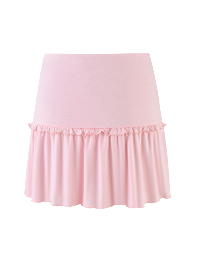 The KATYA MINI SKIRT by TIGERMIST is a pale pink mini skirt with a high waist and ruffled hem, crafted from soft, smooth jersey fabric.