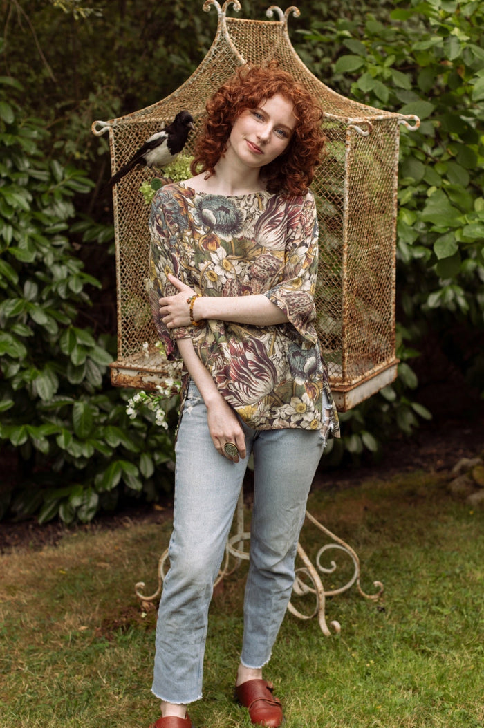 Model wearing the Love Grows Wild Luxe Tee featuring lush floral etchings inspired by 1700s botanical art with hidden bee trim detail – Market of Stars.