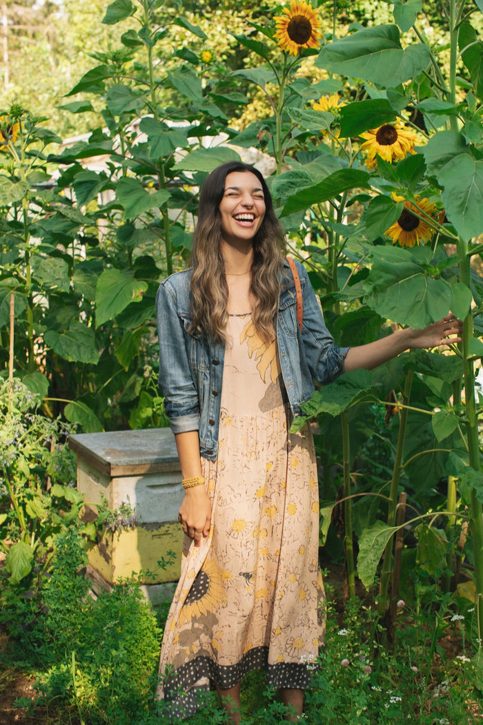 Model wearing the Milk & Honey Bohéme Slip Dress featuring nostalgic 1904 Brooklyn artwork, vintage woodcut stars, and Hoytema’s antique floral print – Market of Stars.