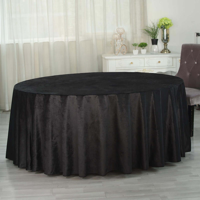 Round black tablecloth draped elegantly on a table in a bright room.