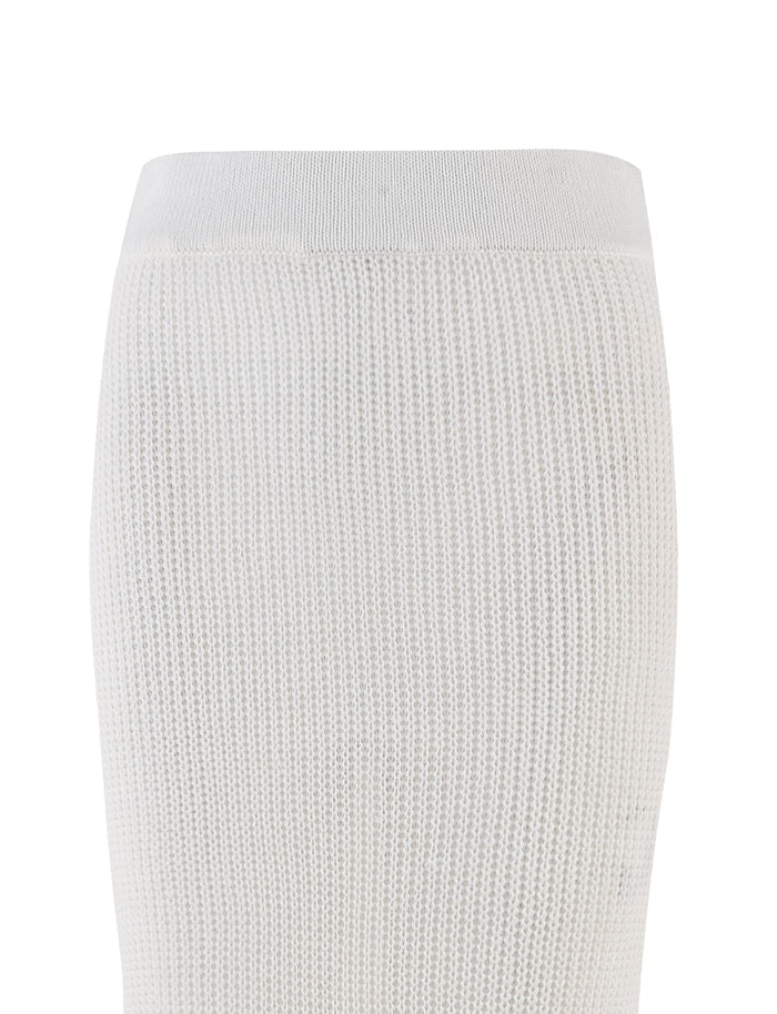 An up-close look at the RAMSEY SKIRT - WHITE by TIGERMIST reveals its textured knit design featuring an elasticated waistband. The fabric is stretchy with a subtle, intricately woven pattern, showcasing the upper portion of this crochet skirt against a simple background.