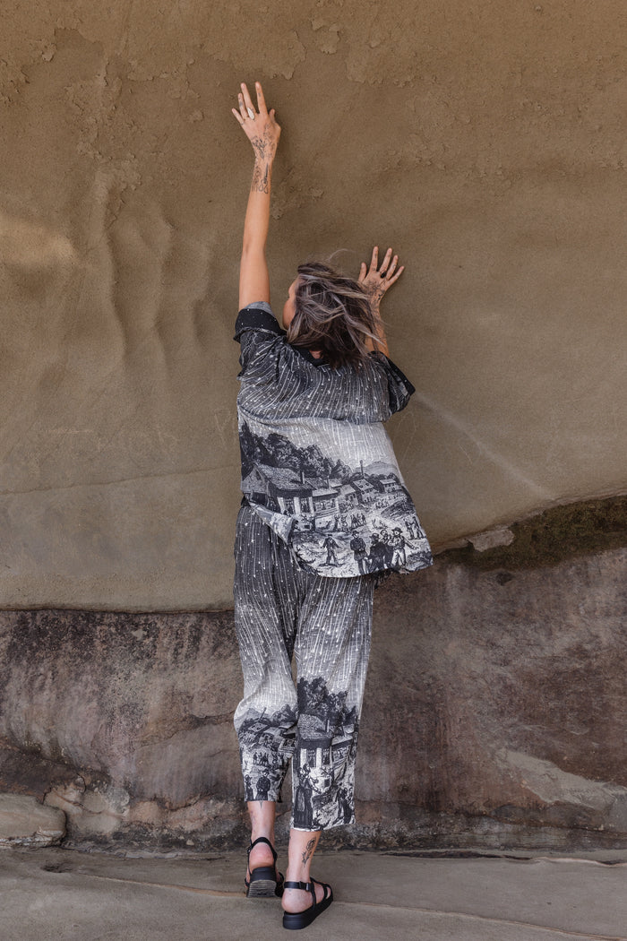 Model wearing a celestial mid-length kimono duster in bamboo & wood blend viscose ft. the 1833 Leonid meteor shower in a dreamy star-filled night sky - Market of Stars.