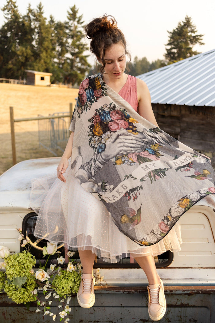 Model wearing Take My Hand scarf with 1600s hand engraving of clasped hands, a painted heart, florals and sun rays – Market of Stars