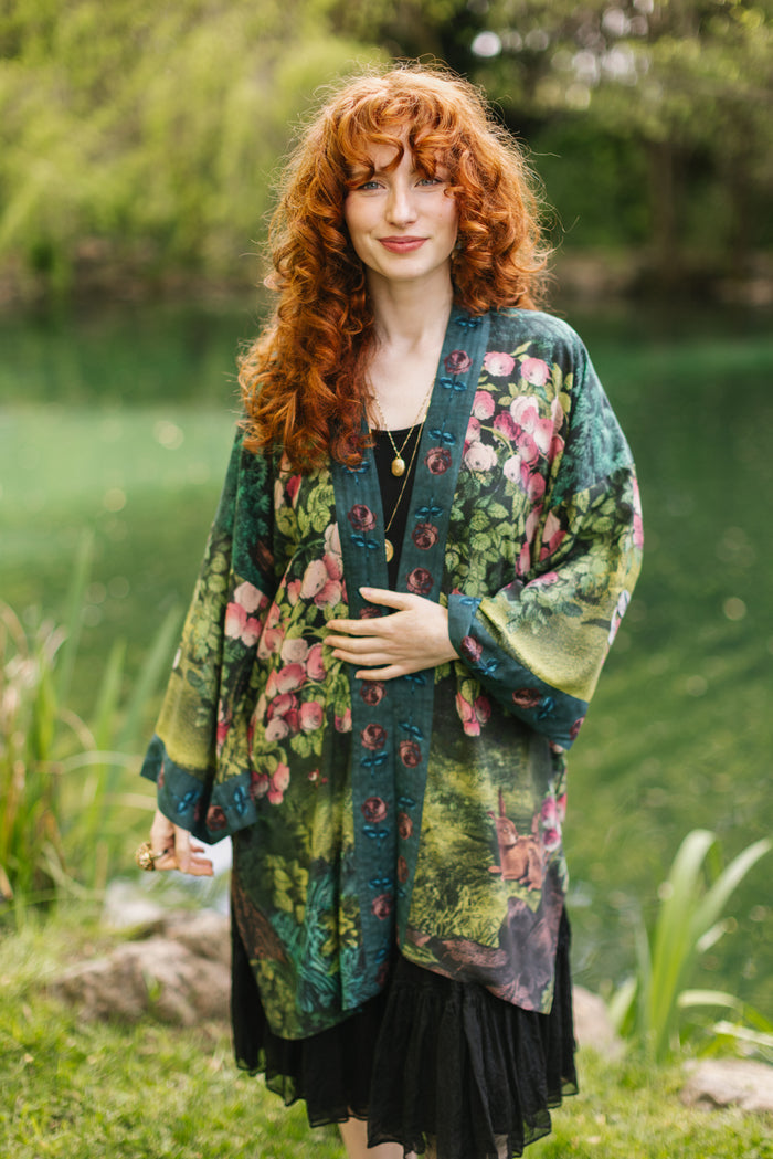 Model wearing a mid-length duster robe ft. hand-coloured etching from the 1880s called The Bower of Roses - Market of Stars