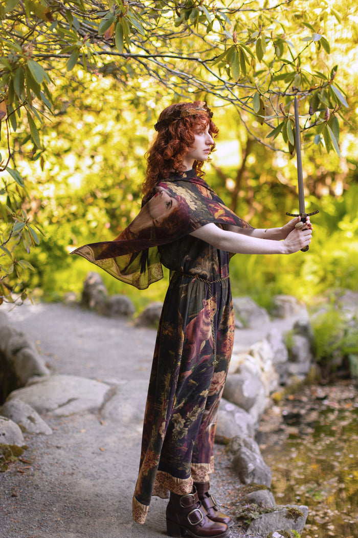 Model wearing a bamboo-viscose scarf featuring florals from centuries-old paintings and Rosetti’s iconic portrait of Joan of Arc - Market of Stars