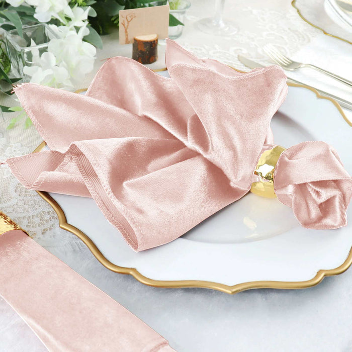 Elegant pink velvet napkin elegantly arranged on a decorative plate.