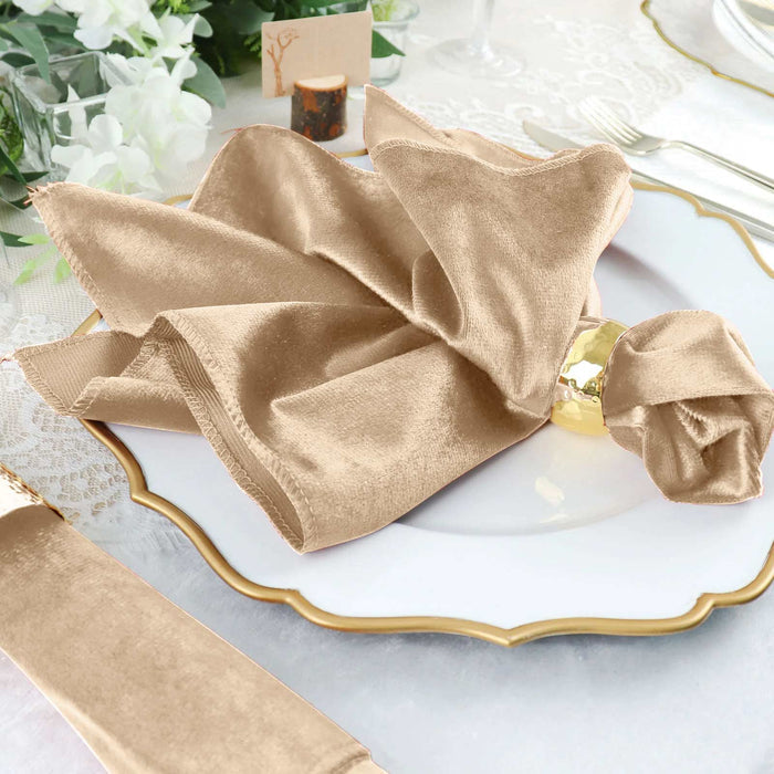 Elegant beige velvet napkin styled on a decorative plate for dining.