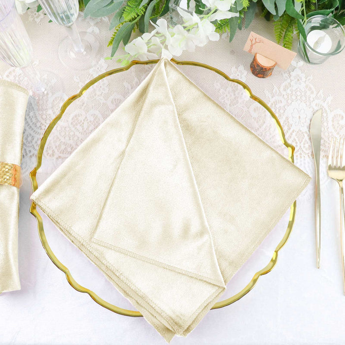 Elegant gold napkin displayed on a decorative plate at a refined table setting.