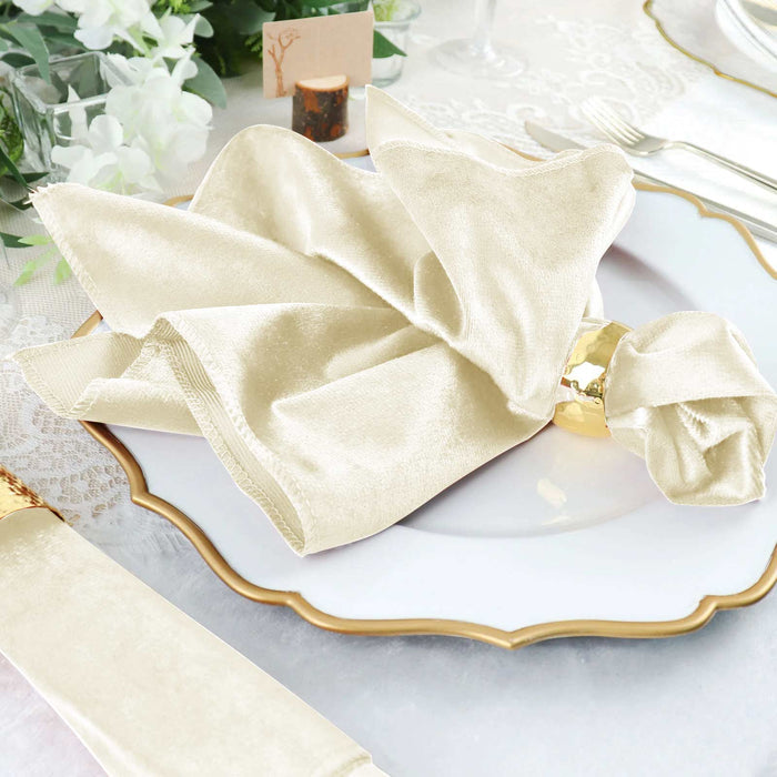 Elegant cream napkin on a decorative plate with gold trim.