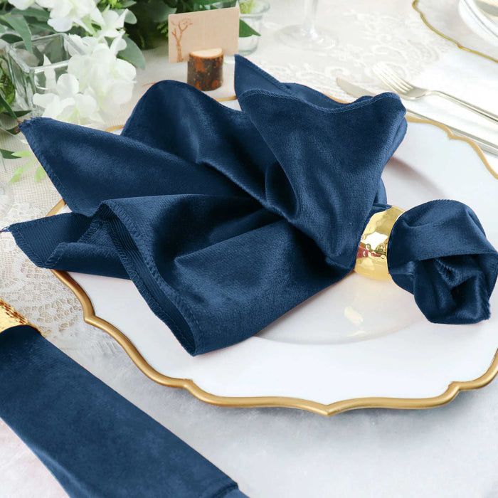 Navy blue napkin elegantly folded on a decorative white plate.
