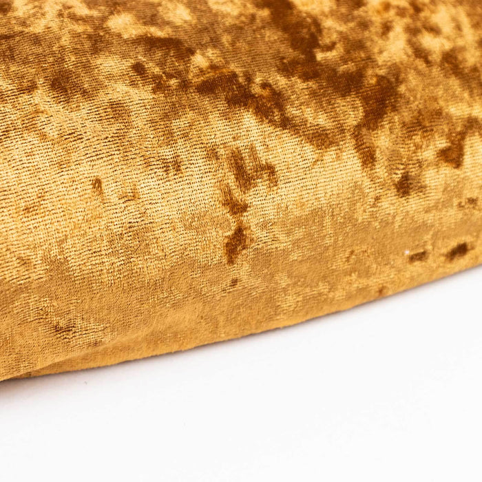 Gold velvet fabric texture close-up shot.