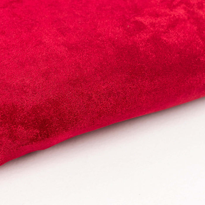 Red velvet fabric texture close-up shot.
