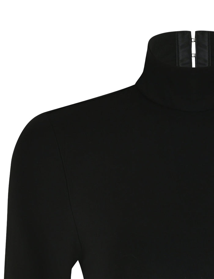 A close-up view of the AKARI BODYSUIT in black from TIGERMIST, showcasing a zipper detail at the back of the neck. The fabric looks smooth and slightly stretchy, with part of the shoulder and upper sleeve visible.