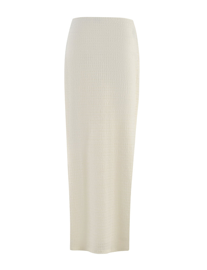 The ALDRIDGE SKIRT by TIGERMIST is a high-waisted, white ankle-length pencil skirt crafted from a slightly textured jersey fabric. Its simple and fitted design offers a sleek, elegant appearance.
