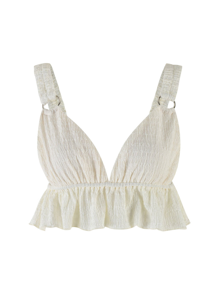 Introducing the ALDRIDGE TOP - WHITE from TIGERMIST, a textured jersey bralette featuring adjustable shoulder straps and a ruffled hem. The fabric boasts a slightly crinkled appearance, adding a unique touch to its design. This crop-length piece is elegantly displayed against a plain white background.