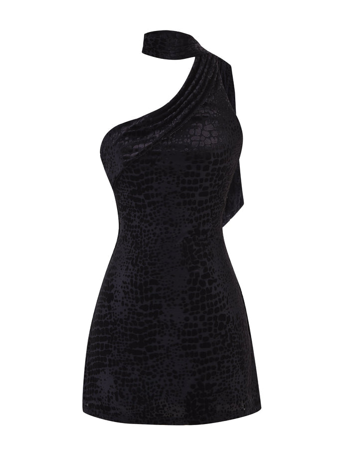 Introducing the Allira Burnout Mini Dress 2.0 by Tigermist: a stunning one-shoulder dress crafted in luxurious black velvet with a unique snake burnout pattern. This mini dress features a draped shoulder design, creating an elegant and modern silhouette.