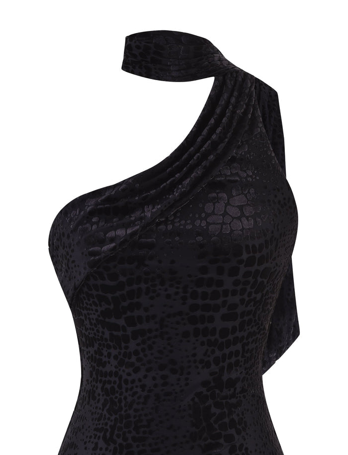 The Allira Burnout Mini Dress 2.0 in Black: Snake by Tigermist is a stunning one-shoulder piece featuring a textured snake skin pattern. With its draped, asymmetrical neckline, this dress showcases chic elegance and effortlessly draws attention. Crafted with luxurious velvet burnout fabrication, it offers a unique and sophisticated style.