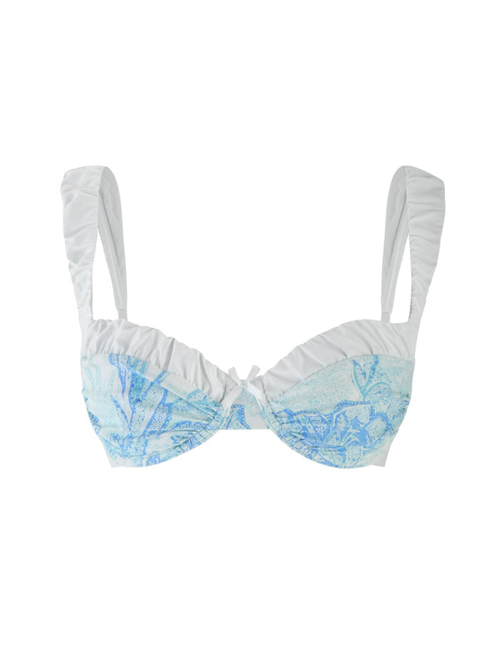 The AMARAN BIKINI TOP - BLUE : FLORAL TAPESTRY by TIGERMIST is a balconette bikini top in white and light blue with floral patterns, featuring wide, gathered straps and a ruched center.
