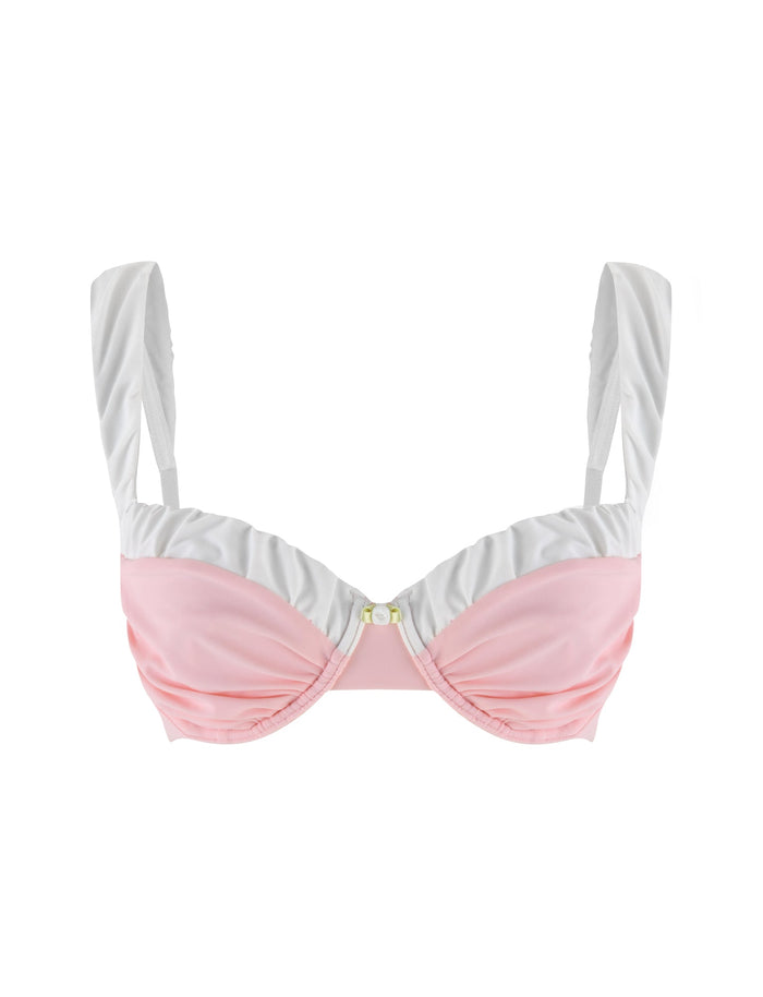 The AMARAN BIKINI TOP in pastel pink by TIGERMIST features a classic bikini top design, complete with wide straps and a small decorative element at the center, set against a plain white background.