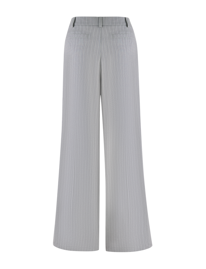 The AMBERLY SUIT PANT in grey pinstripe by TIGERMIST features a light gray wide-leg tailored fit, shown from the back with two welt pockets, classic belt loops, and is crafted from premium suiting fabric.
