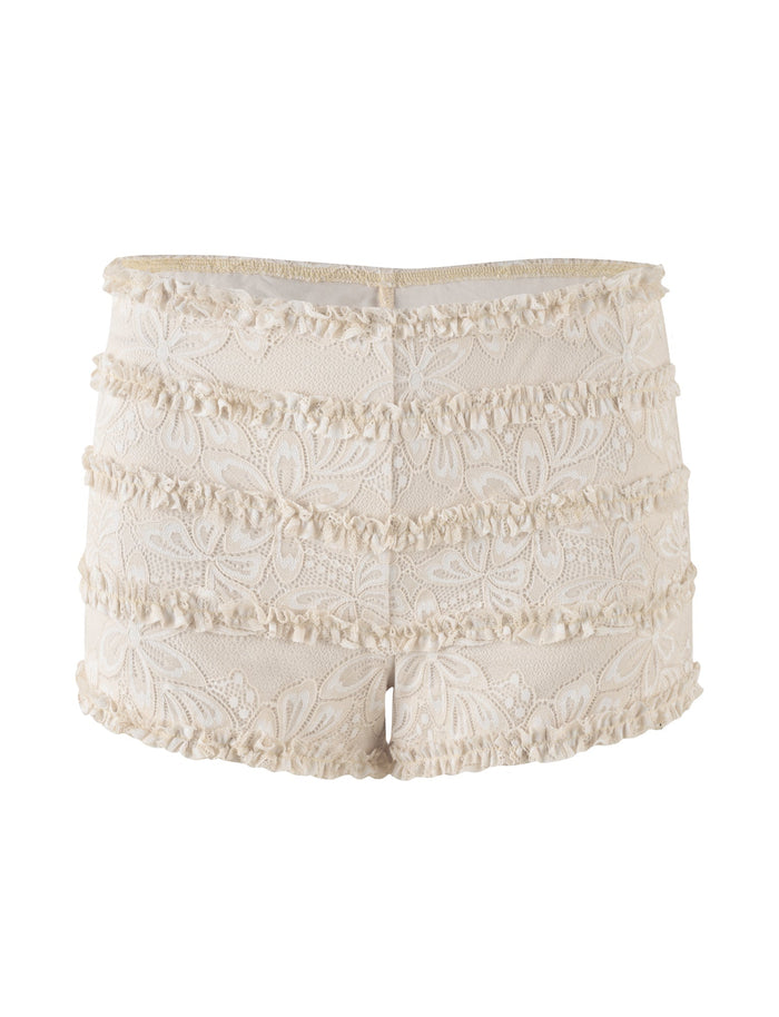 The ANELISA SHORT by TIGERMIST is a pair of white lace mini shorts featuring a delicate floral pattern. These mid-rise waist shorts are adorned with horizontal ruffled layers, adding texture and a feminine touch.