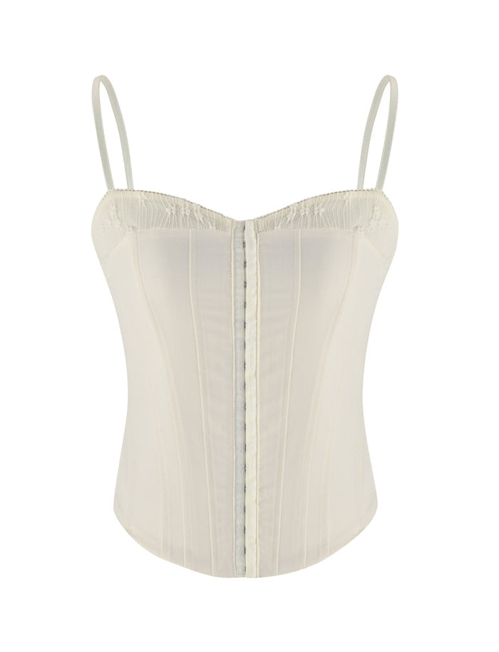 The ANTONELLA TOP by TIGERMIST in white, bone, or cream is a soft-touch suiting corset top with thin adjustable straps, vertical seams, and a structured, form-fitting silhouette.