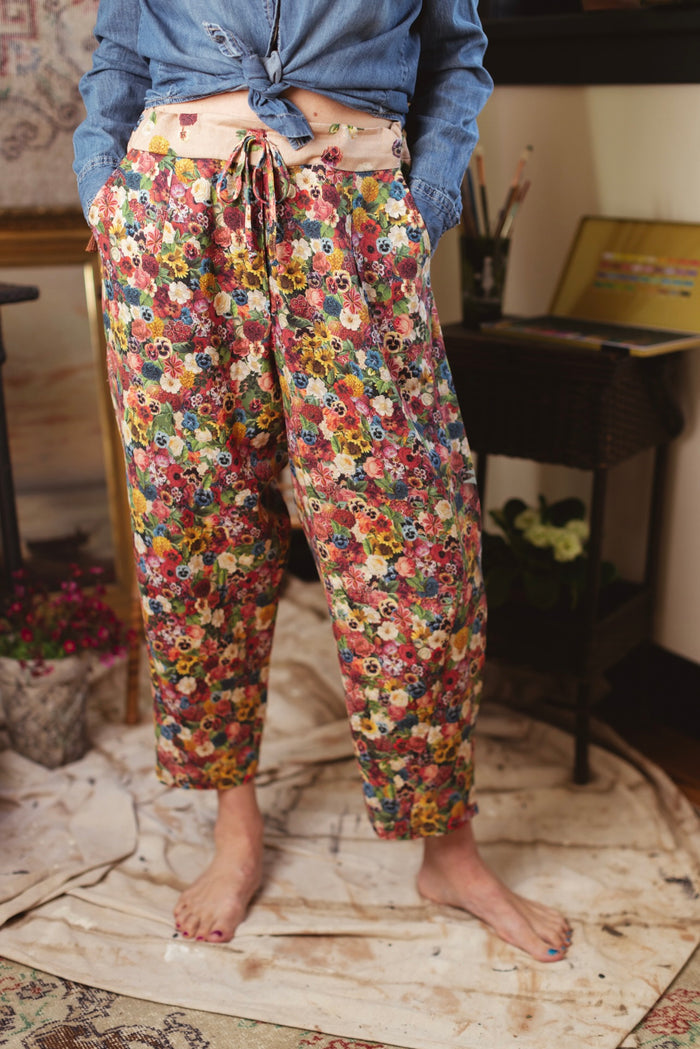 Artist pants featuring a whimsical print of 50 antique seed catalogue flowers arranged on a painter’s palette with a Monet quote – Market of Stars.