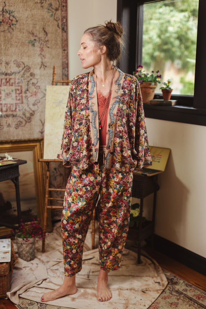 Artist pants featuring a whimsical print of 50 antique seed catalogue flowers arranged on a painter’s palette with a Monet quote – Market of Stars.