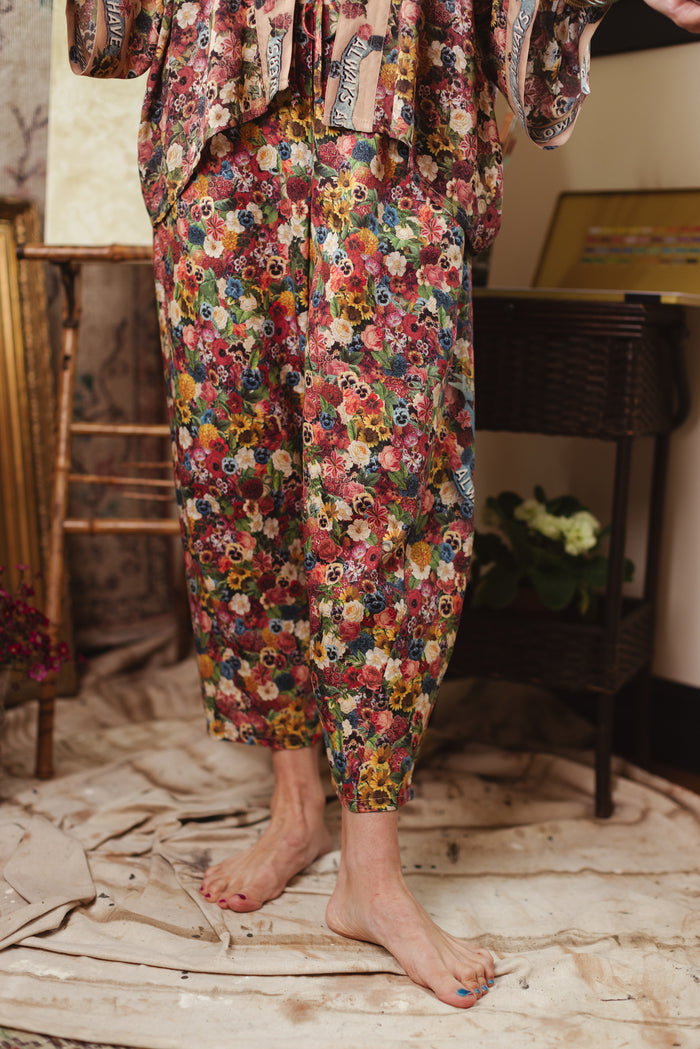 Artist pants featuring a whimsical print of 50 antique seed catalogue flowers arranged on a painter’s palette with a Monet quote – Market of Stars.