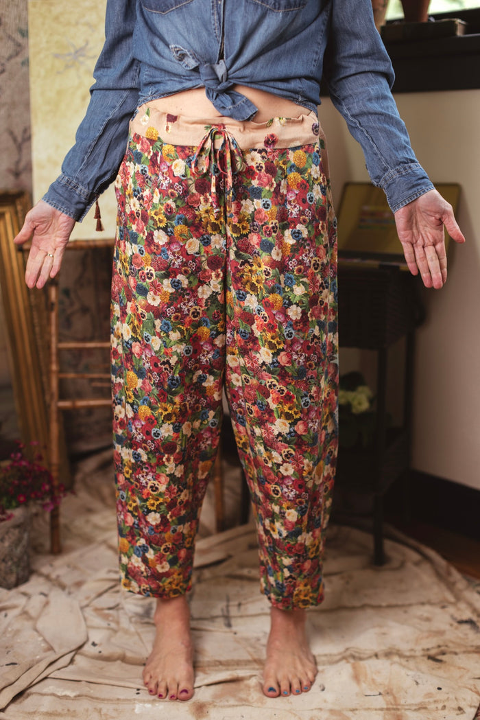 Artist pants featuring a whimsical print of 50 antique seed catalogue flowers arranged on a painter’s palette with a Monet quote – Market of Stars.