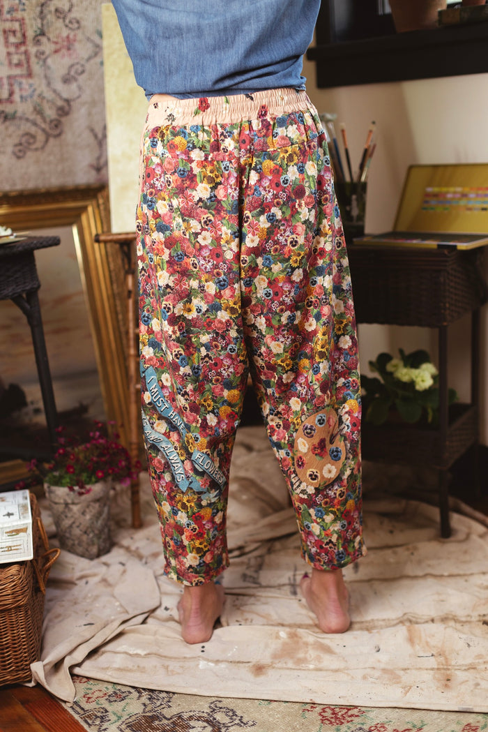 Artist pants featuring a whimsical print of 50 antique seed catalogue flowers arranged on a painter’s palette with a Monet quote – Market of Stars.