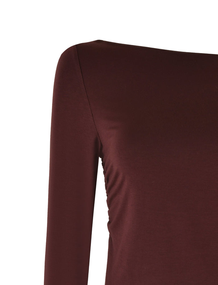 Close-up of the TIGERMIST BIANKA TOP - BROWN : CHOCOLATE, featuring long sleeves in a rich chocolate hue. The smooth, slightly form-fitting material showcases visible ruching along the side seam, emphasizing its bodycon silhouette against a plain white background.