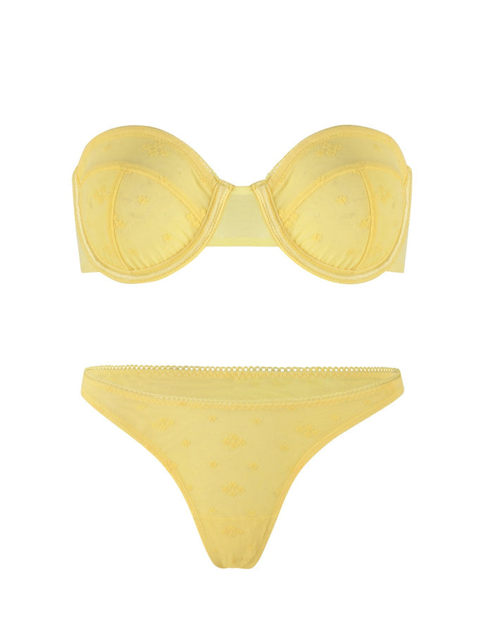 Introducing the TIGERMIST BIM LACE SET in yellow, this ensemble includes a strapless, padded bra with molded cups adorned with light floral embroidery. The matching bottom is a low-rise thong featuring similar floral embroidery and a delicate lace trim at the waistband, enhanced by elegant mesh and lace details for added sophistication.