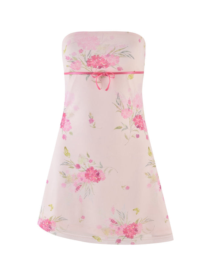 Introducing the TIGERMIST CARSYN MINI DRESS in a stunning watercolour floral print. This dress features a chic strapless neckline adorned with pink and green floral patterns, accented by a delicate pink bow at the chest. The modern design is elegantly finished with an asymmetrical hemline.