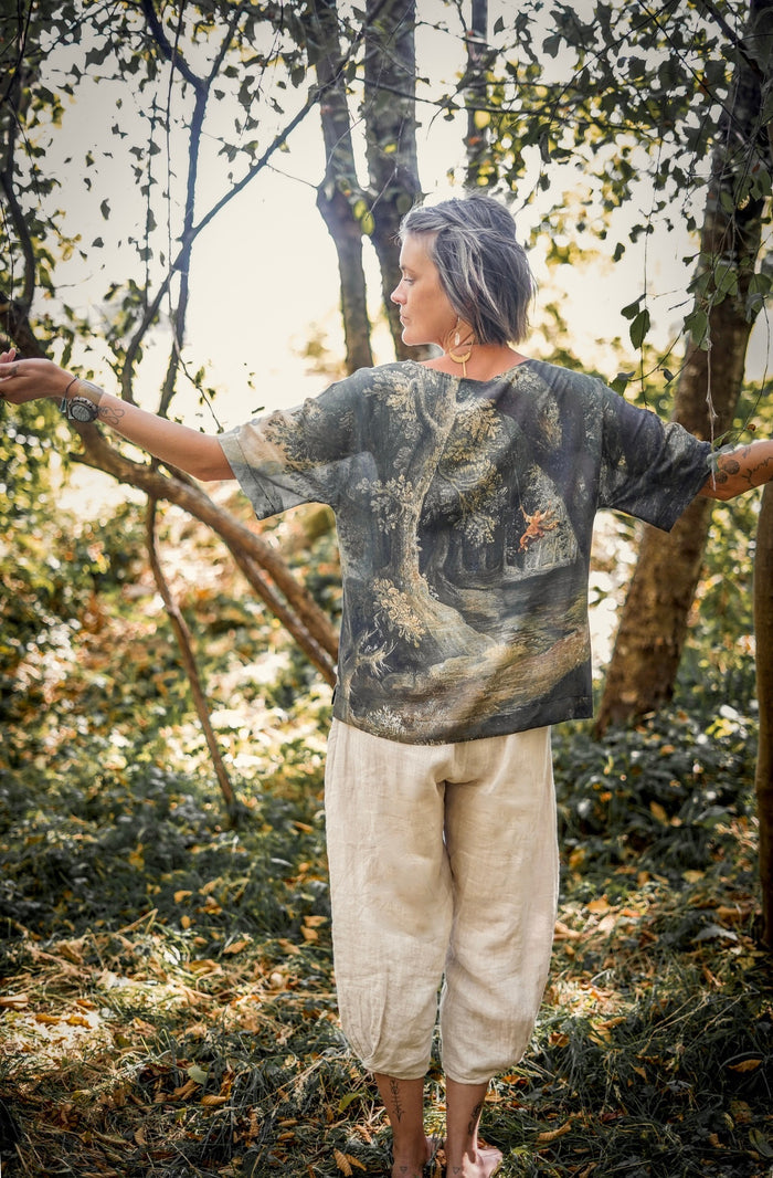 Castles in the Air Luxe Tee featuring Jan Brueghel’s whimsical 1600s landscape and painterly floral trim on soft bamboo-based viscose – Market of Stars.