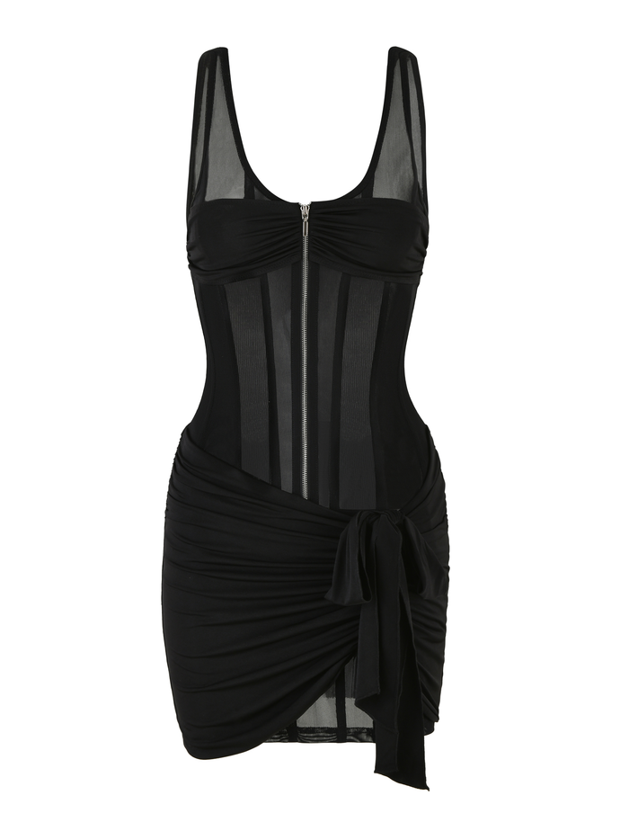 The CATERINA MINI DRESS - BLACK by TIGERMIST is a sleeveless, form-fitting mesh mini with sheer panels, front zipper, ruched skirt with side tie, and a slinky jersey lining for comfort.