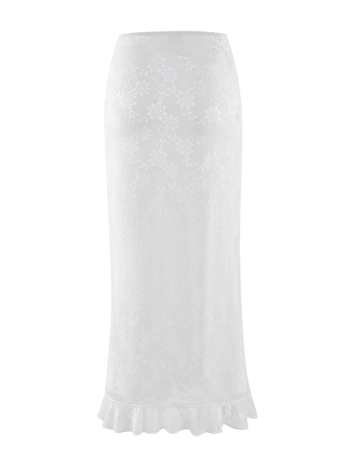 The CHARLEIGH SKIRT - WHITE : LACE by TIGERMIST is a sophisticated white lace skirt adorned with a delicate floral pattern and designed with a low-rise waist, finished elegantly with a ruffled hem.